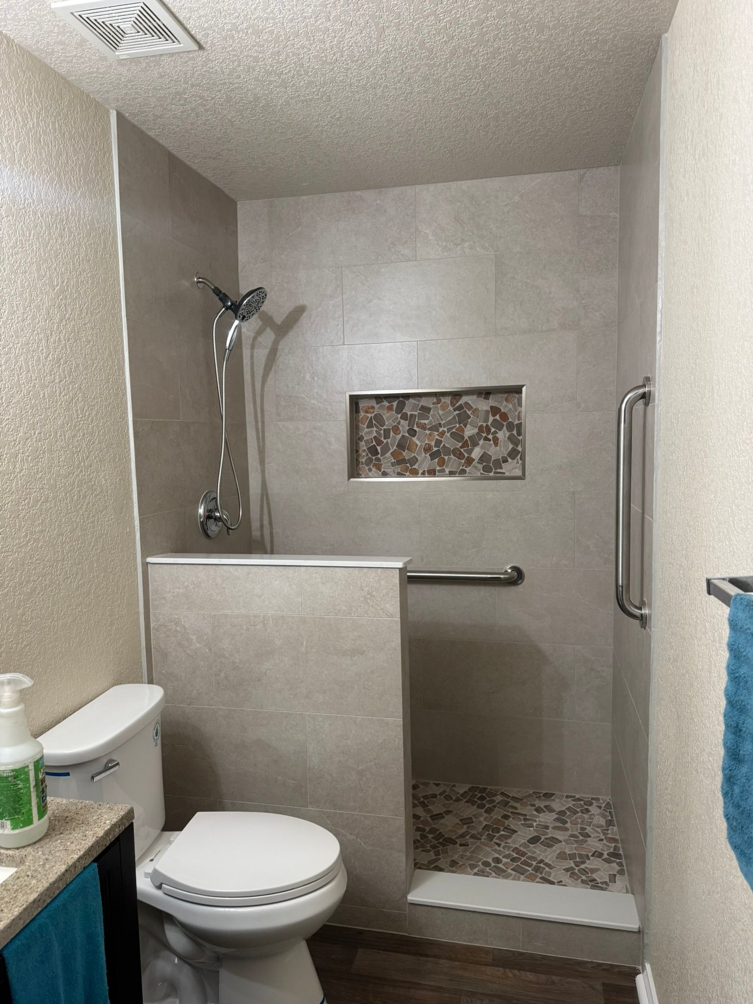 A bathroom with a toilet and a walk in shower.