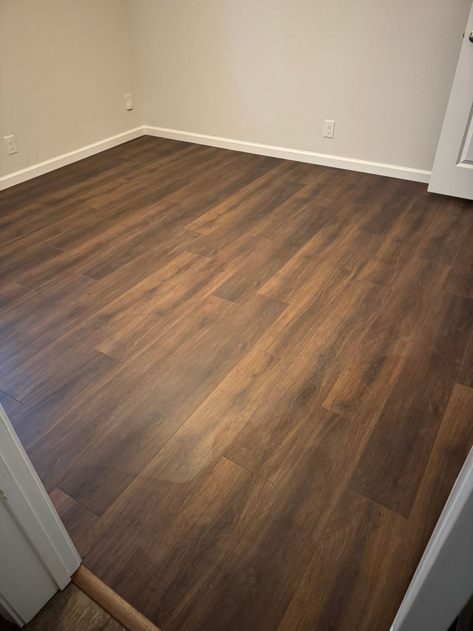 A room with a wooden floor and white walls.