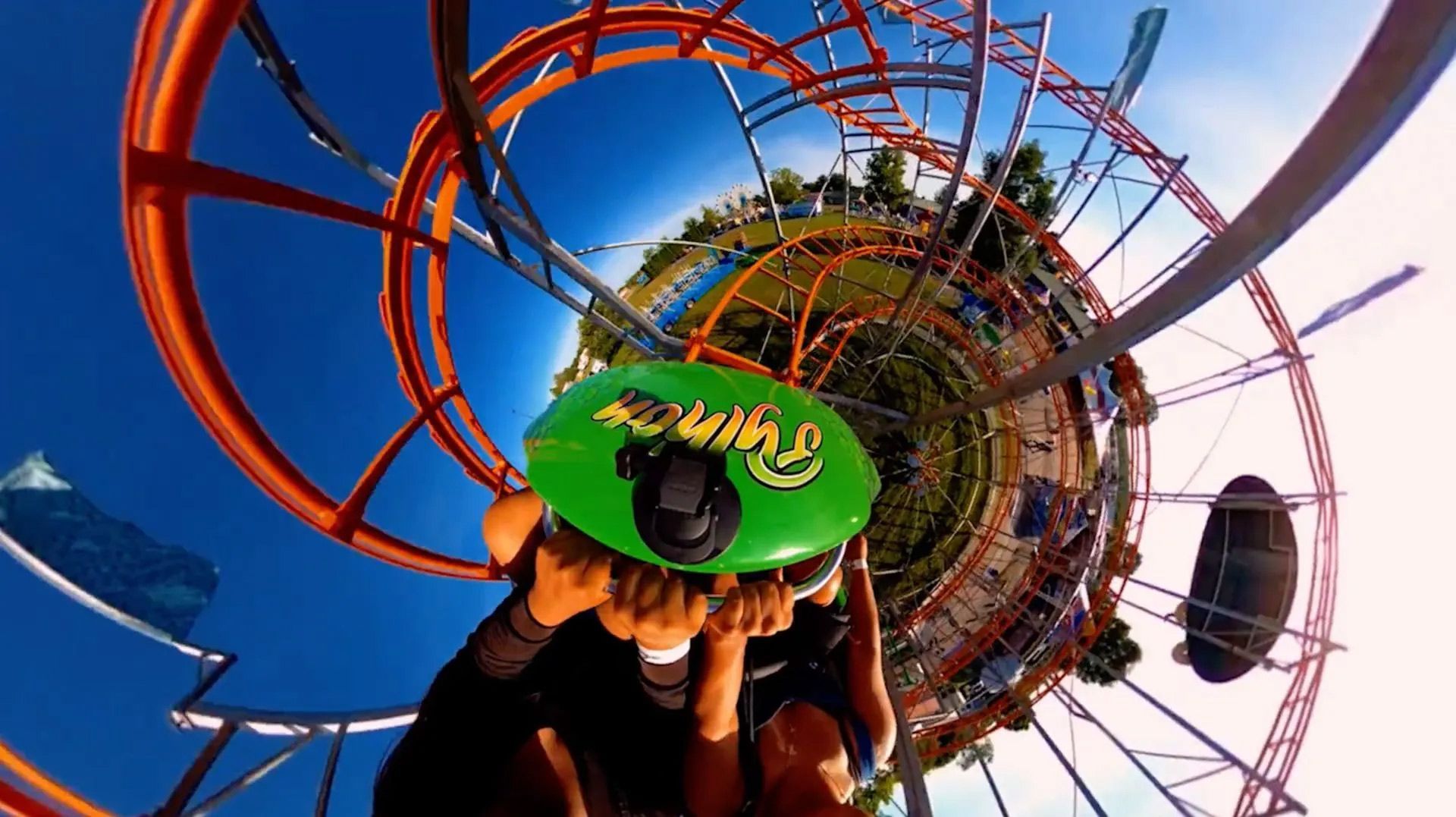 A person is riding a roller coaster at an amusement park.