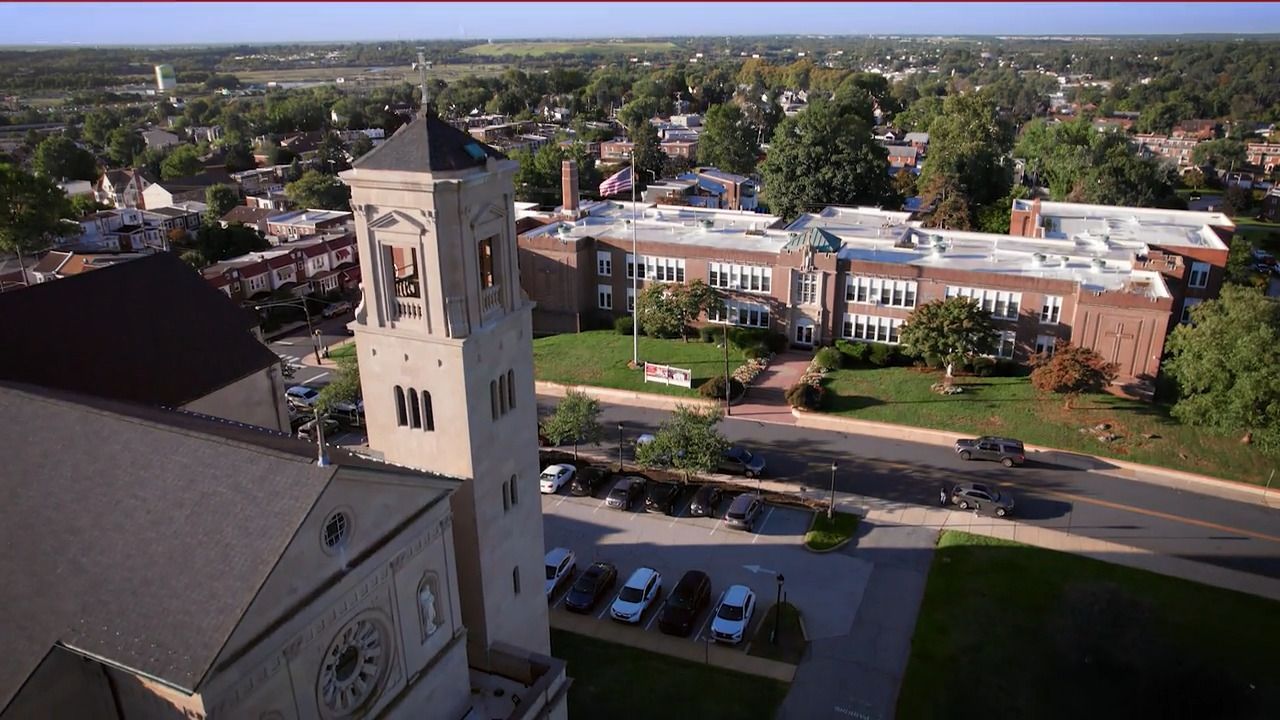 An aerial view of a clock tower in a small town