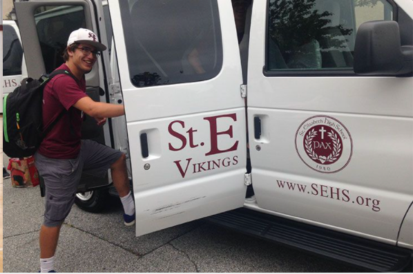A man is getting out of a st. e vikings van