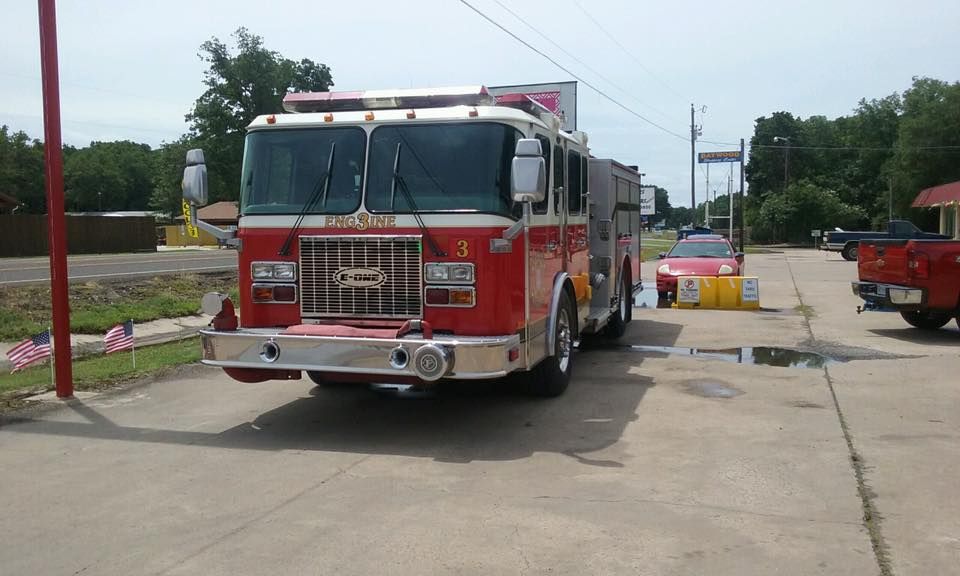A red fire truck is parked on the side of the road