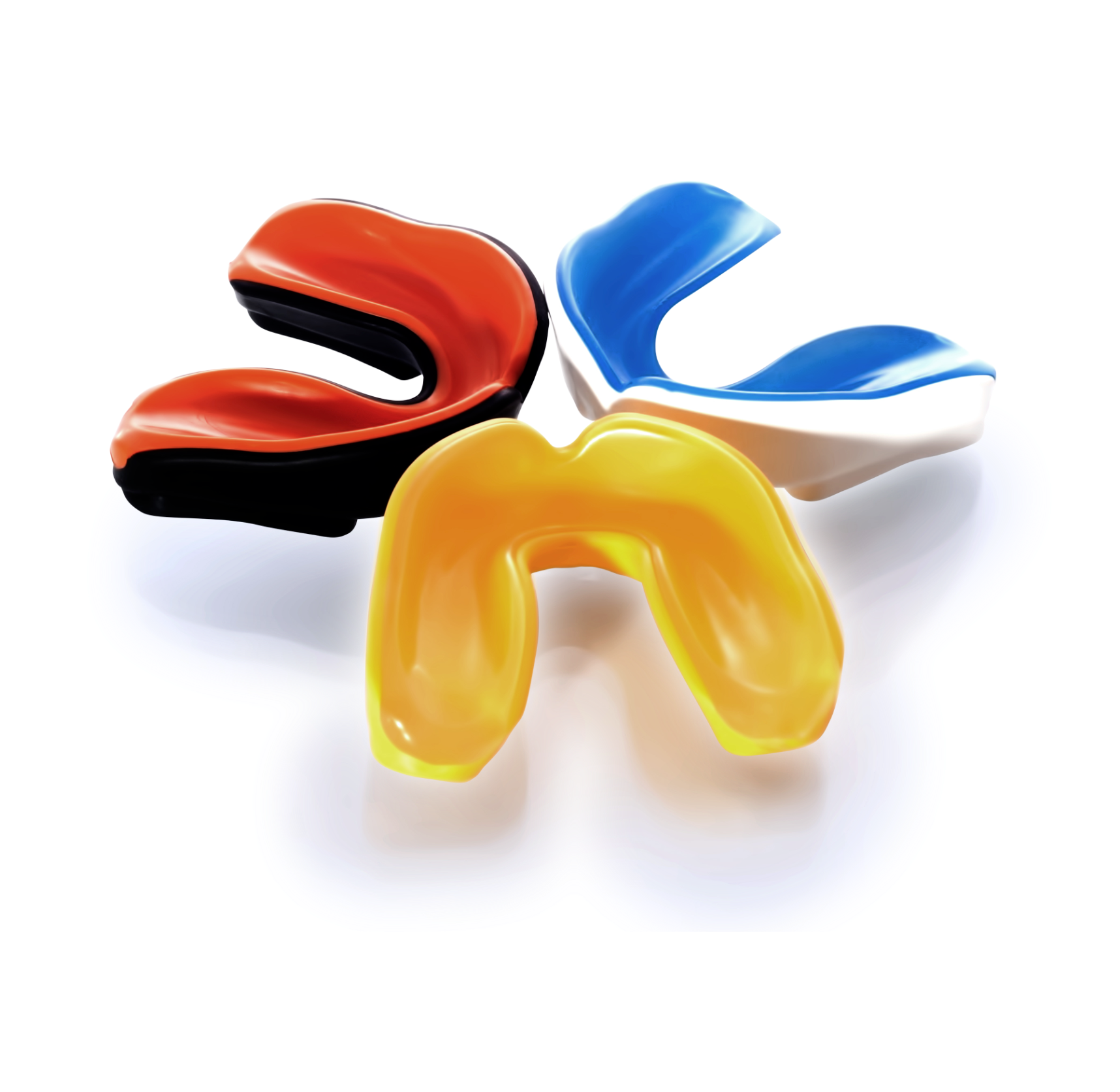 Three mouth guards of different colors are sitting on a white surface