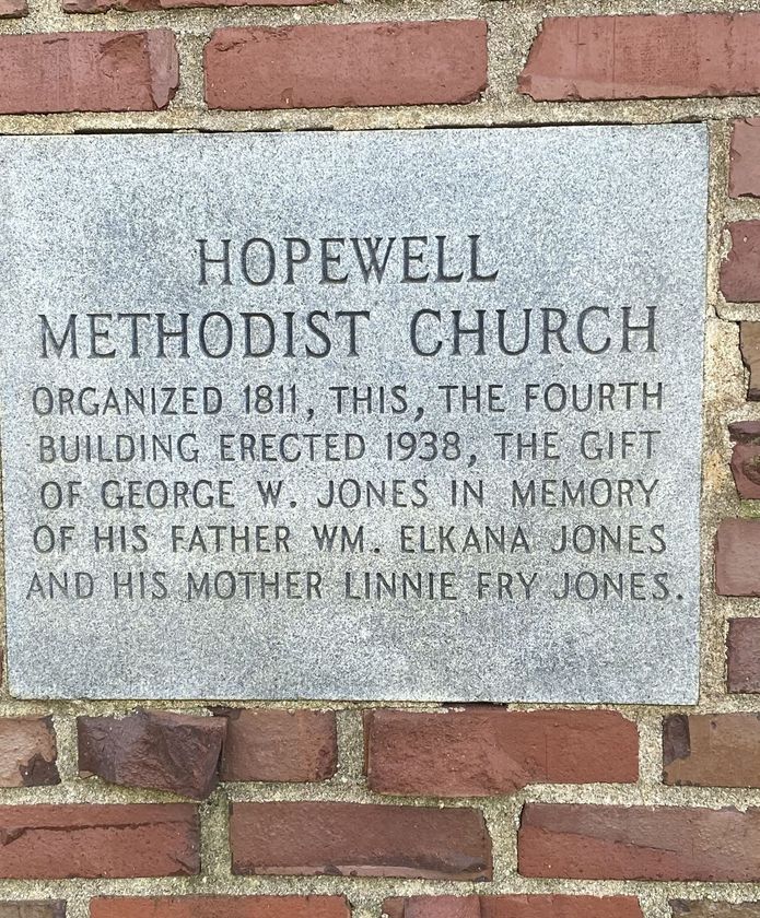 A brick wall with a plaque on it that says hopewell methodist church.