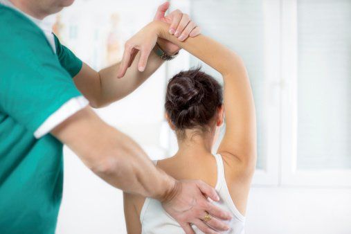 Doctor Bending Patient's Arm — Chiropractic Clinics in Quakertown, PA