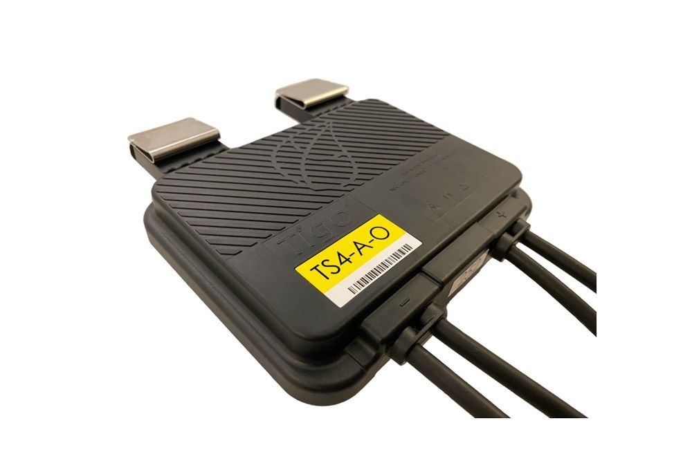 Black electronic device with cables and a yellow label reading
