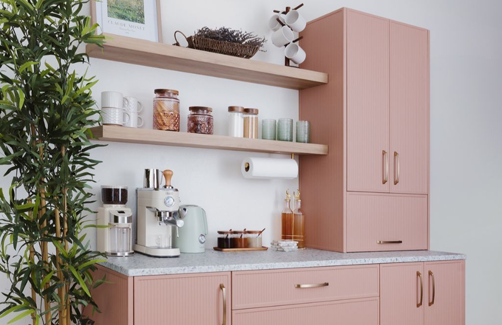 Pink kitchen with wooden shelves, countertop, cabinets, and appliances.