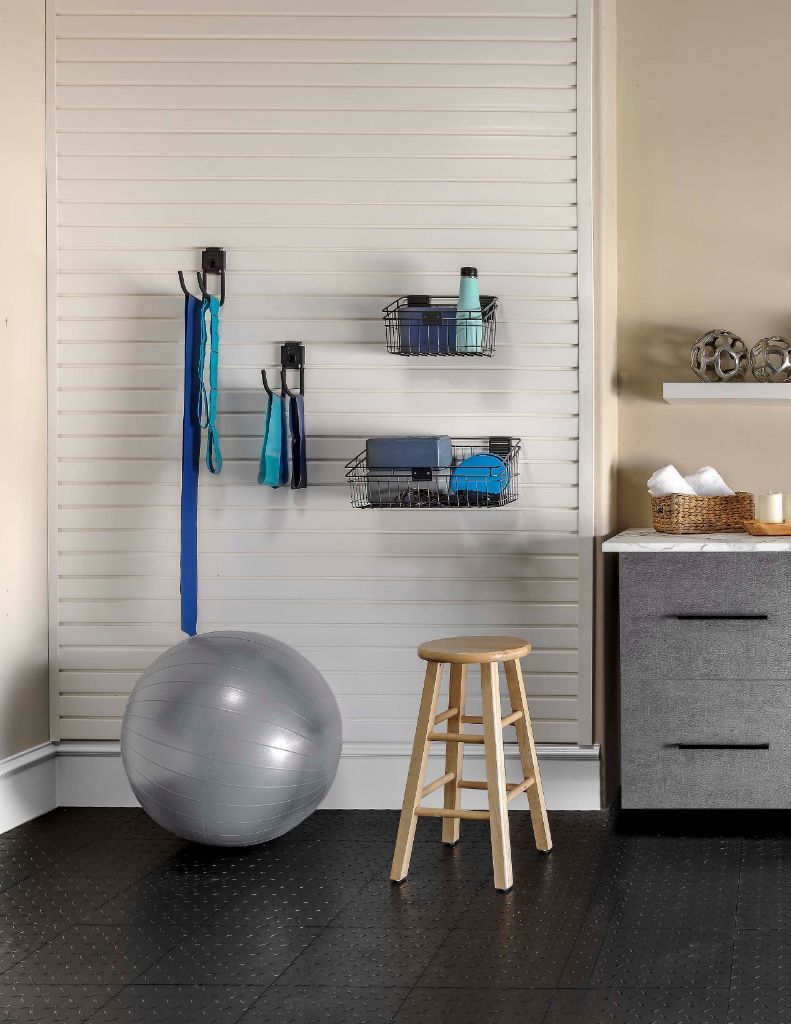 a garage with white cabinets and a black refrigerator .