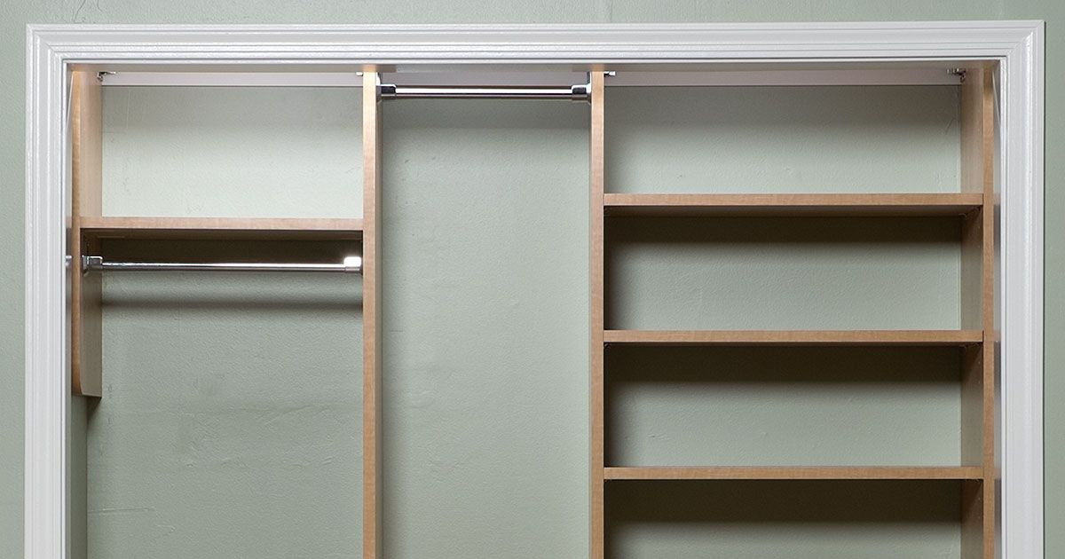 a closet with wooden shelves and a hanging rail .