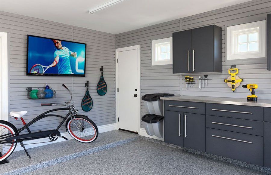 a garage with custom cabinets and slatwall storage organizers