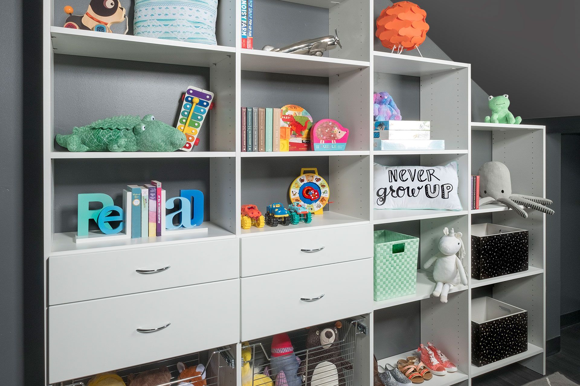 a child 's closet with lots of cubbies and toys