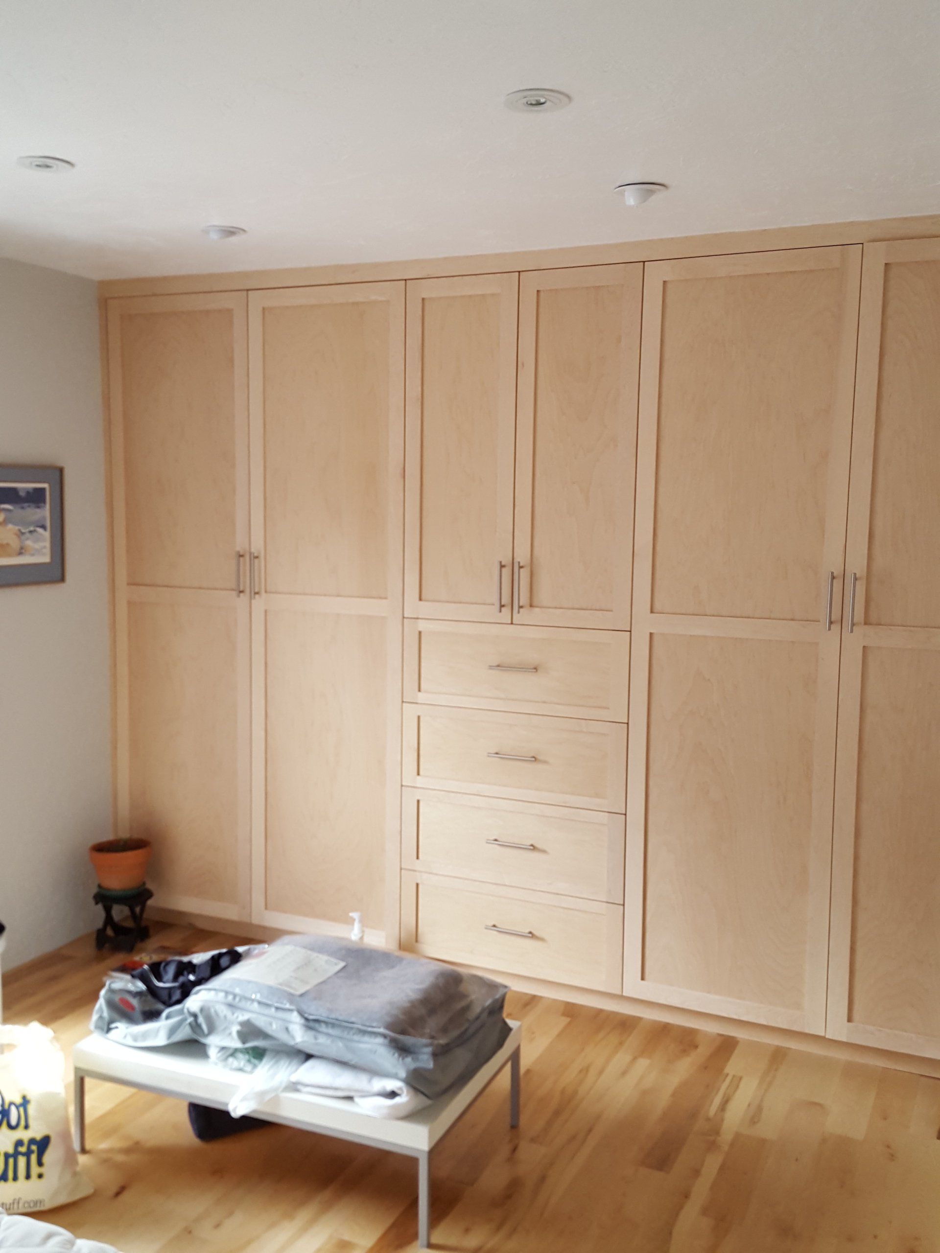 A room with lots of wooden cabinets and drawers