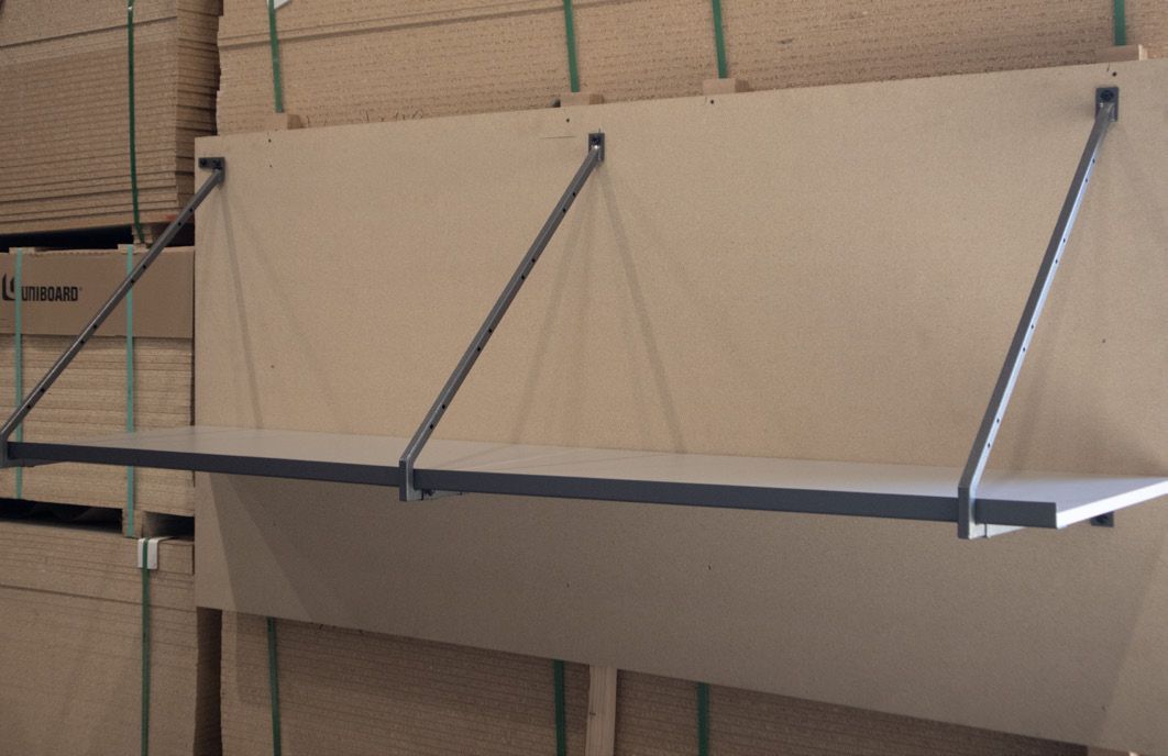 Shelf held by angled metal supports, mounted on a wall.