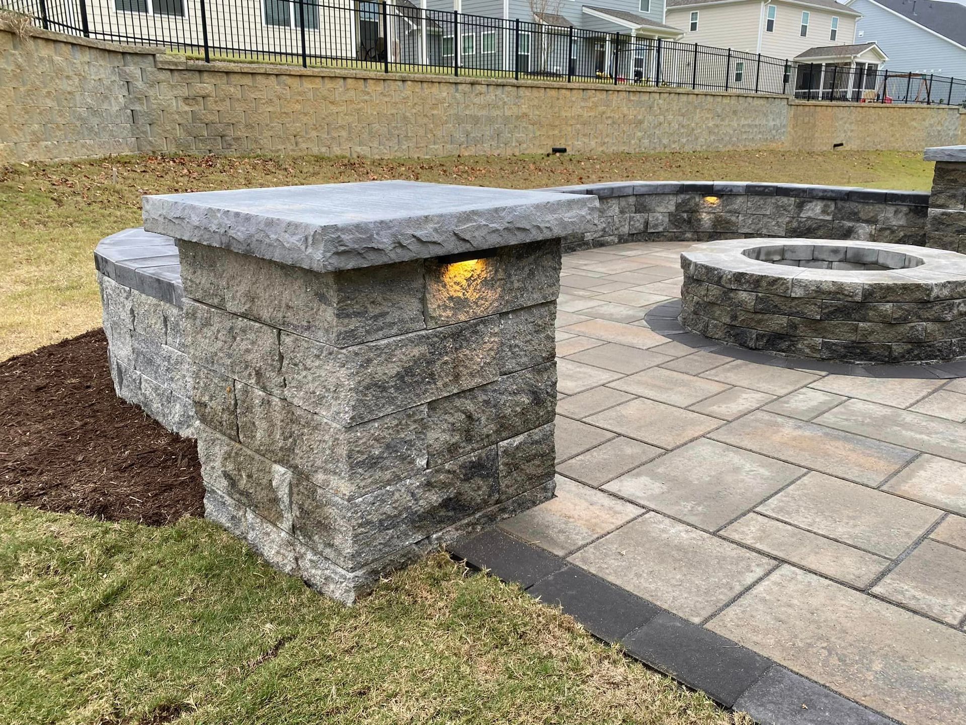 There is a fire pit in the middle of the patio.