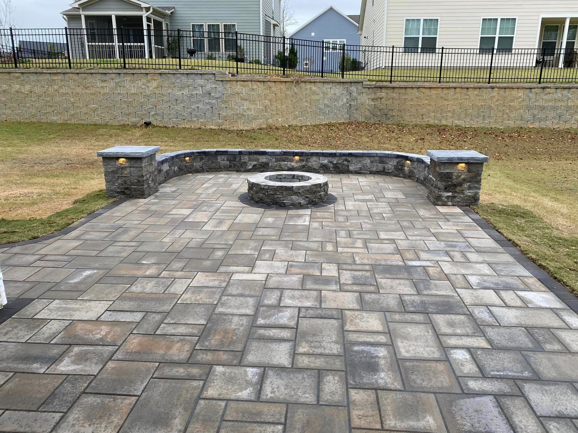 There is a fire pit in the middle of the patio.