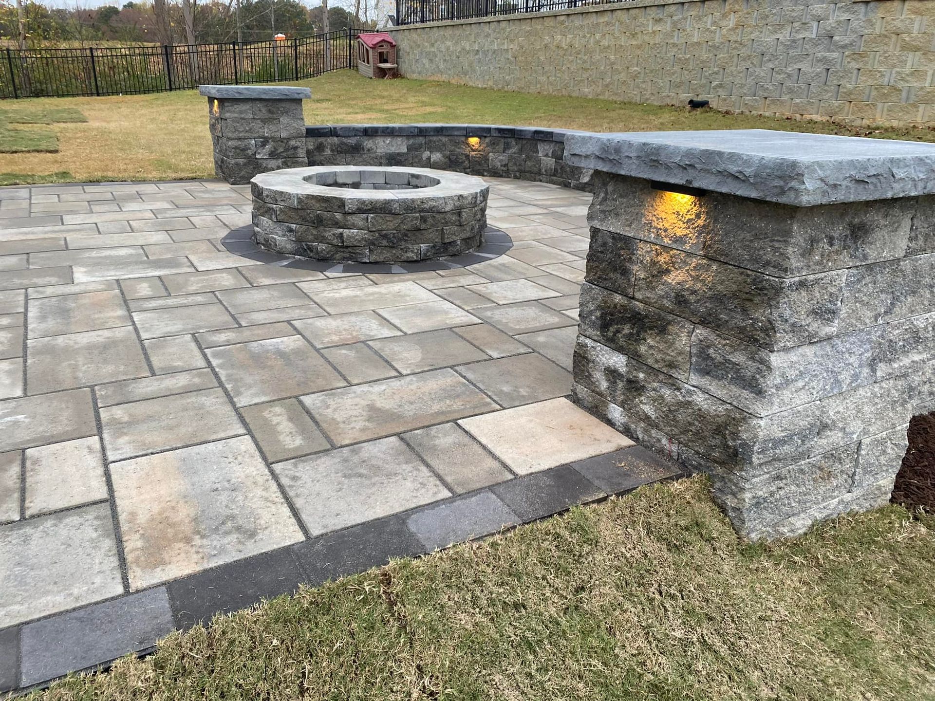 There is a fire pit in the middle of the patio.