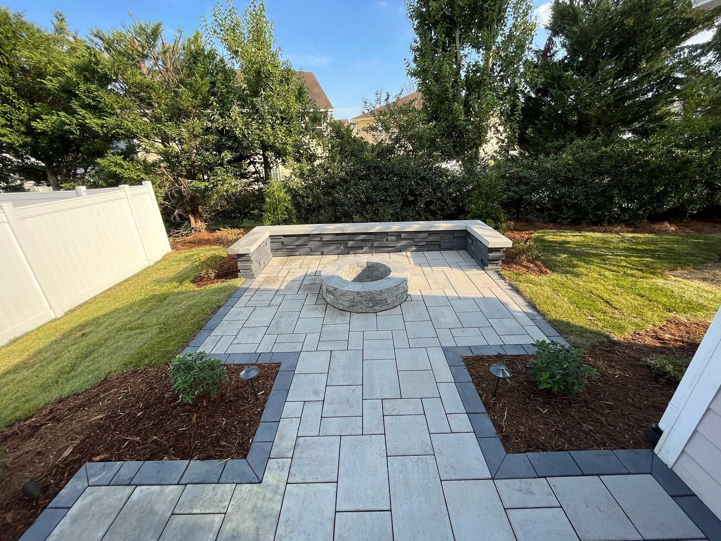 There is a fire pit in the middle of the patio.