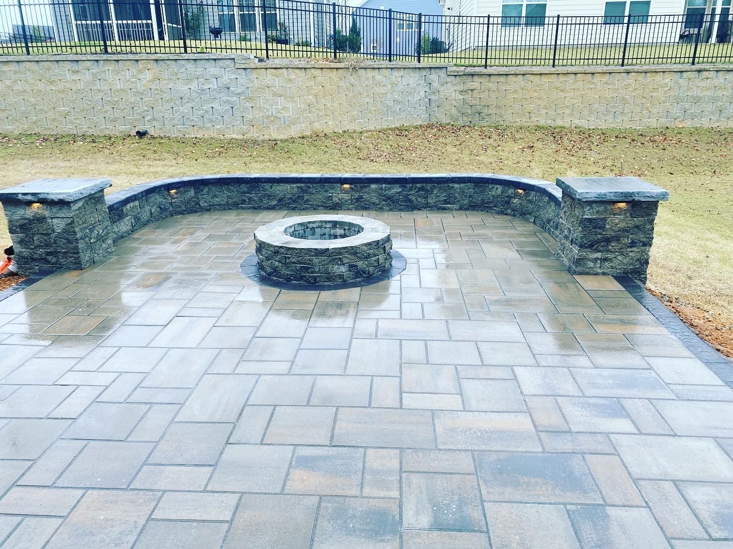 There is a fire pit in the middle of the patio.