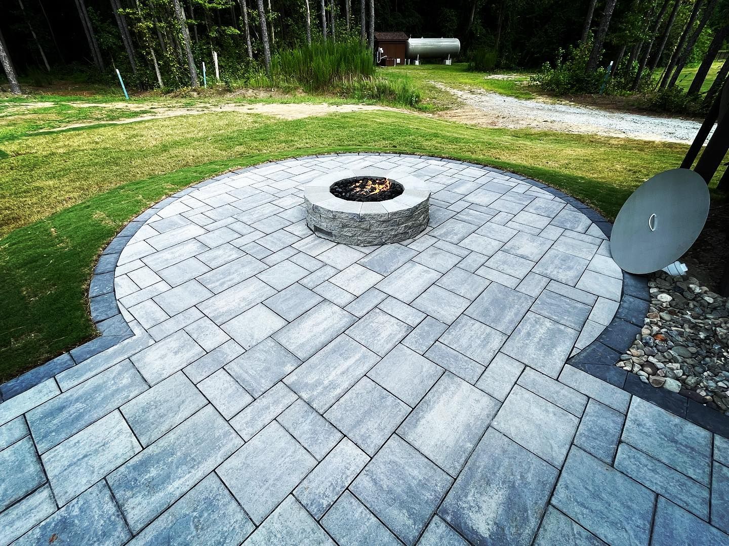 There is a fire pit in the middle of the patio.