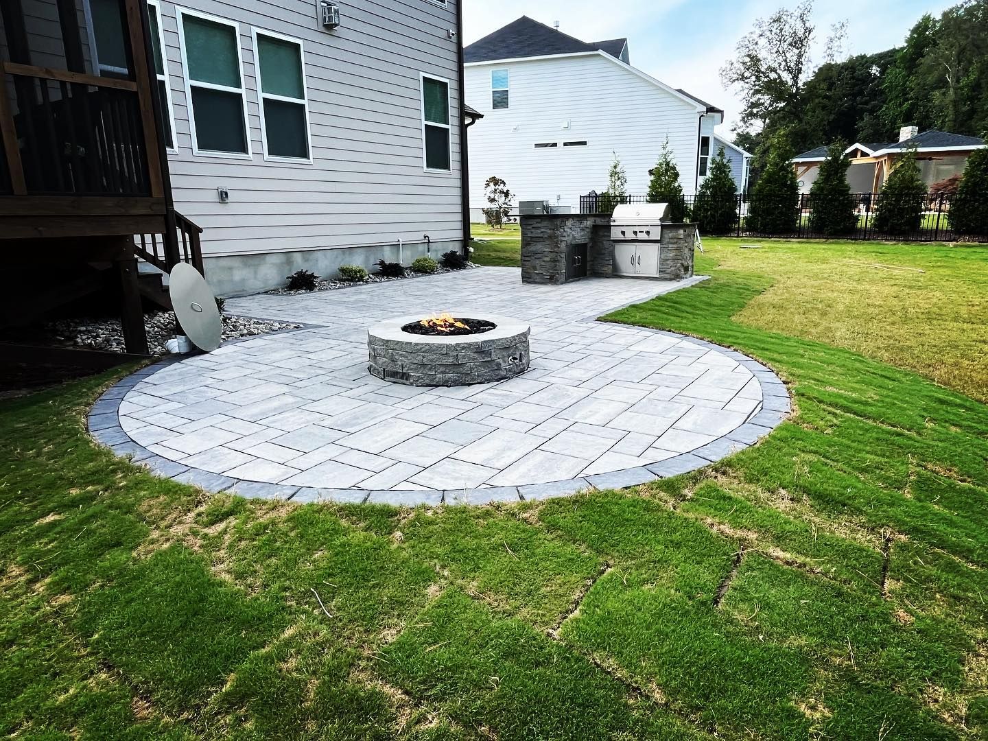 There is a fire pit in the middle of the patio.