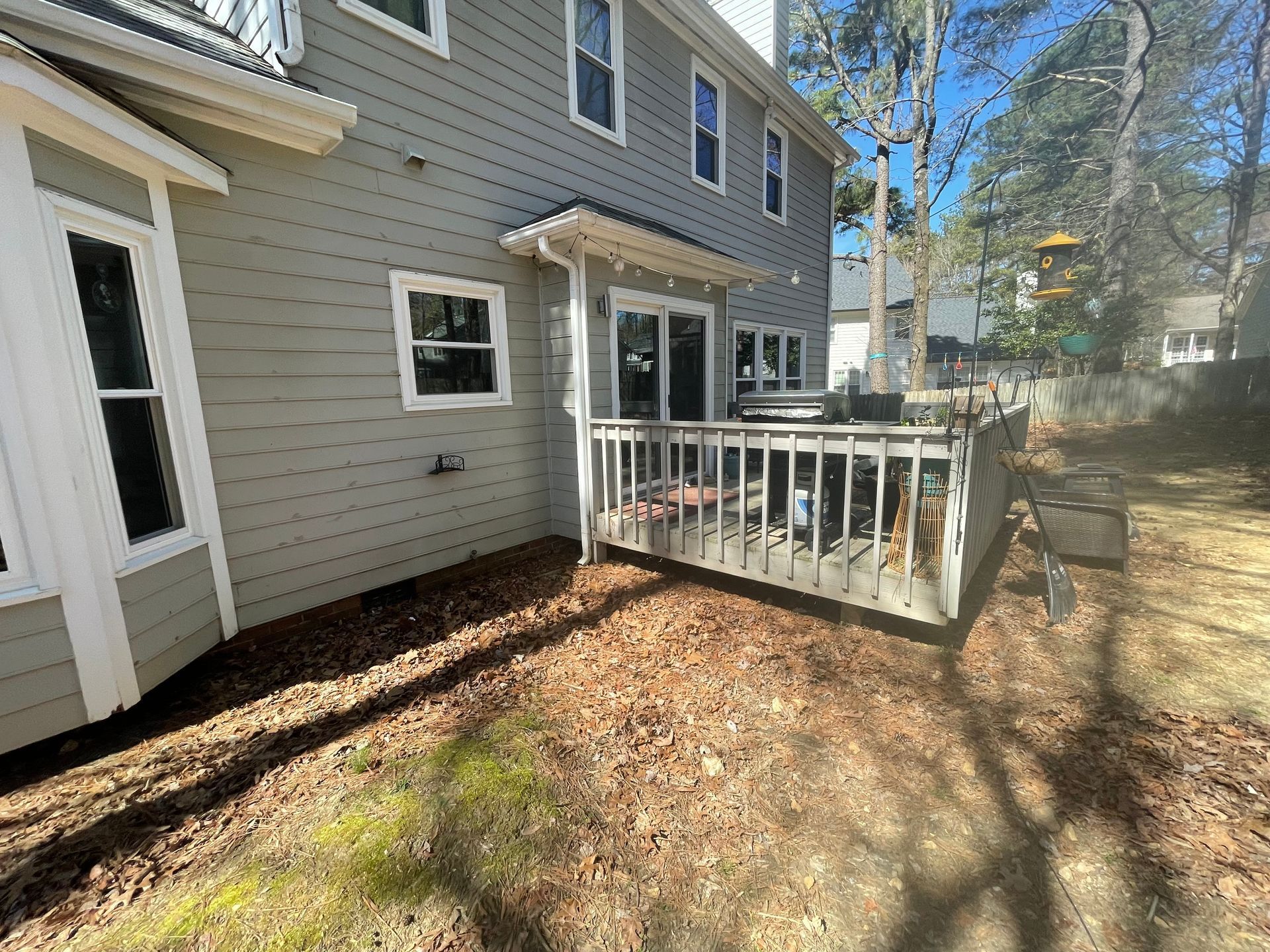 A house with a large deck in the backyard.
