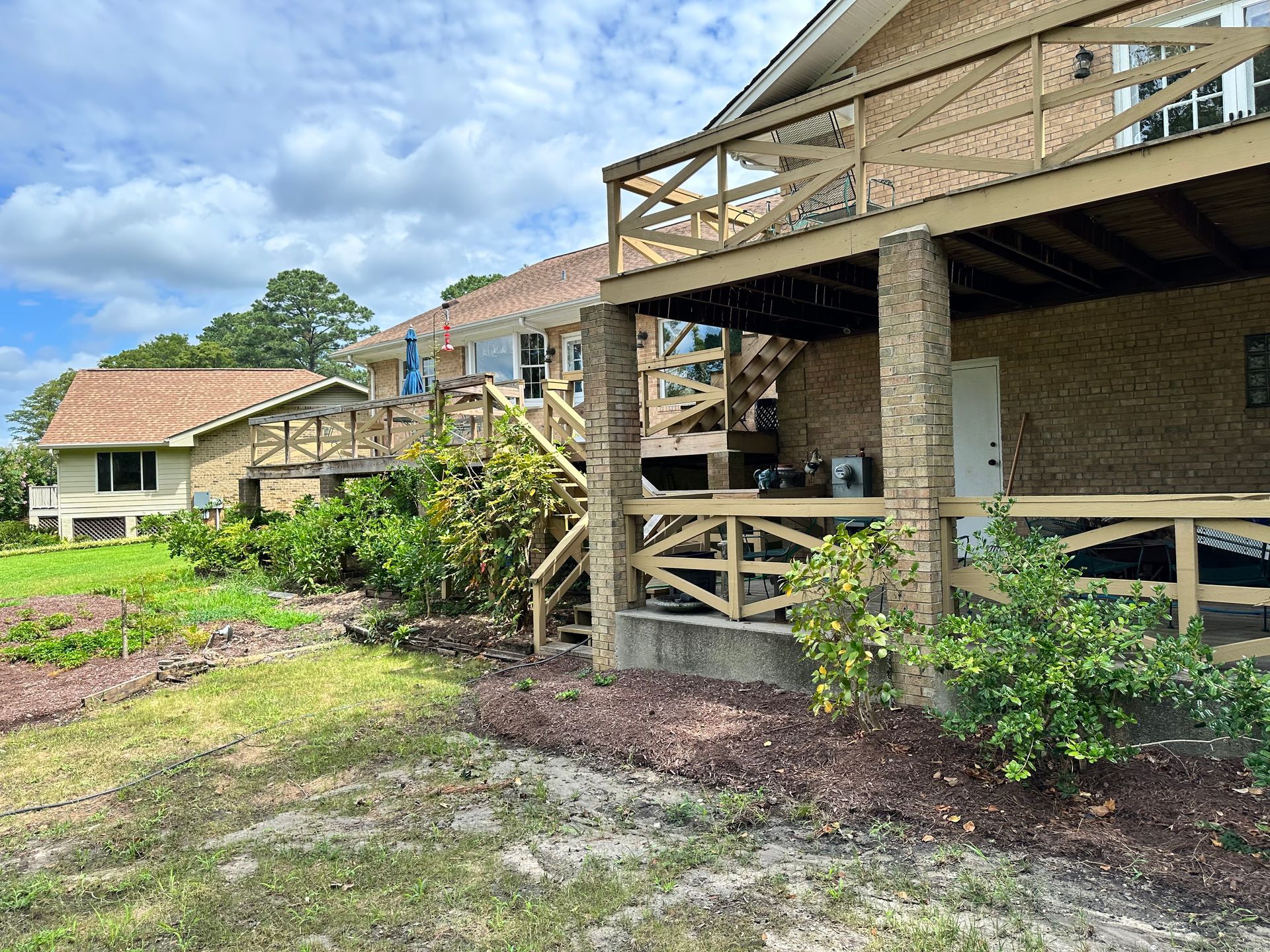 A house with a large porch and stairs leading up to it.