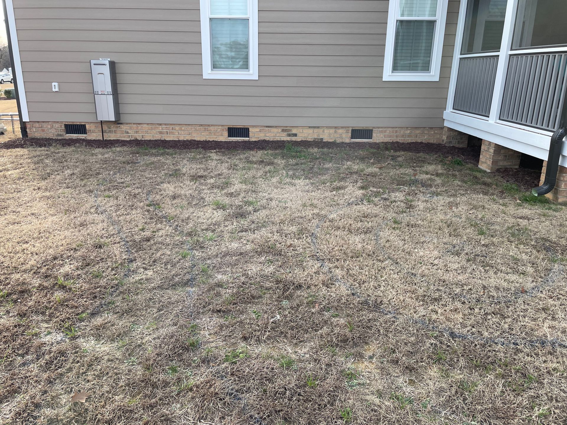 A house with a lot of grass in front of it.