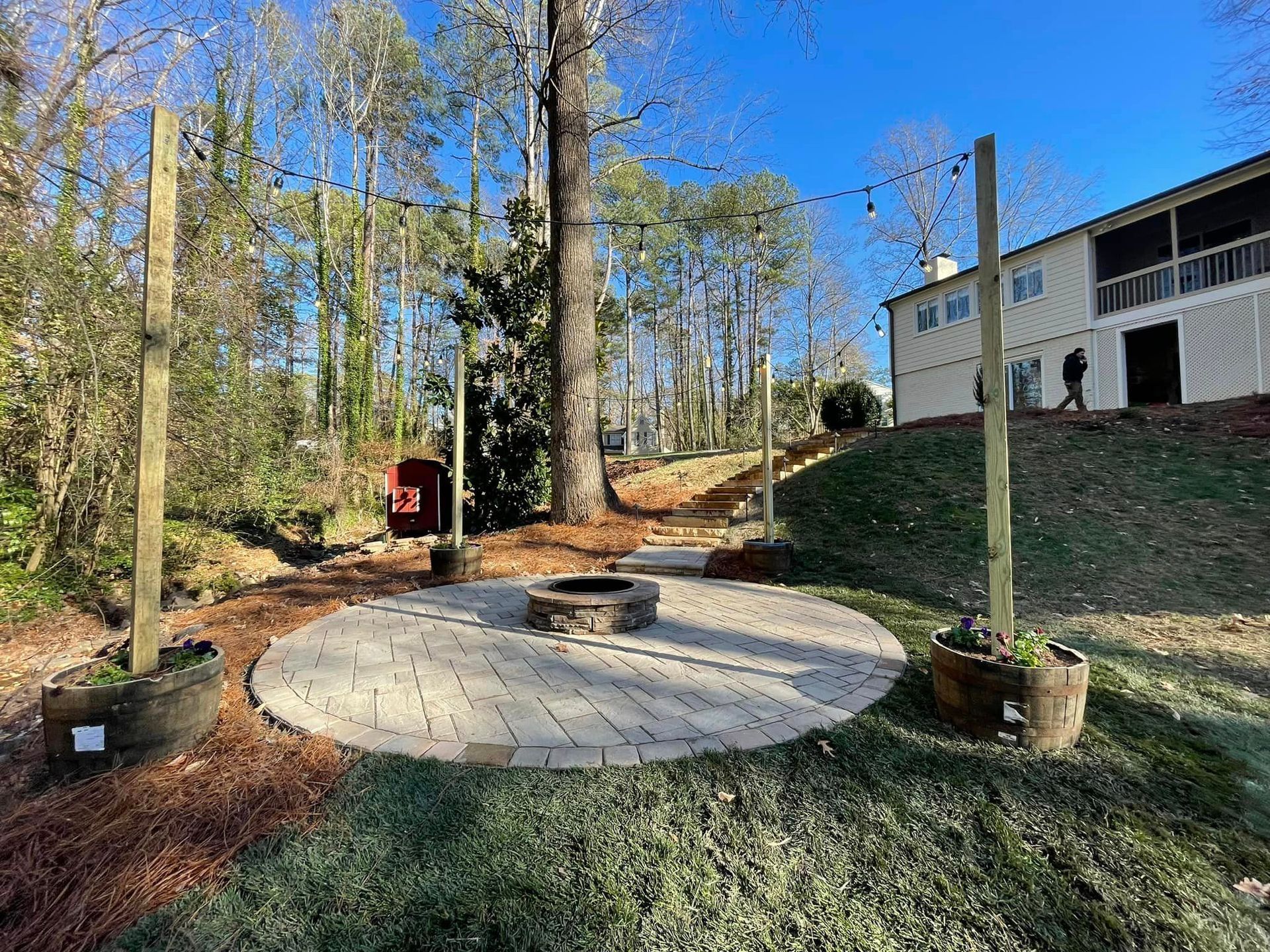 There is a fire pit in the middle of the backyard.
