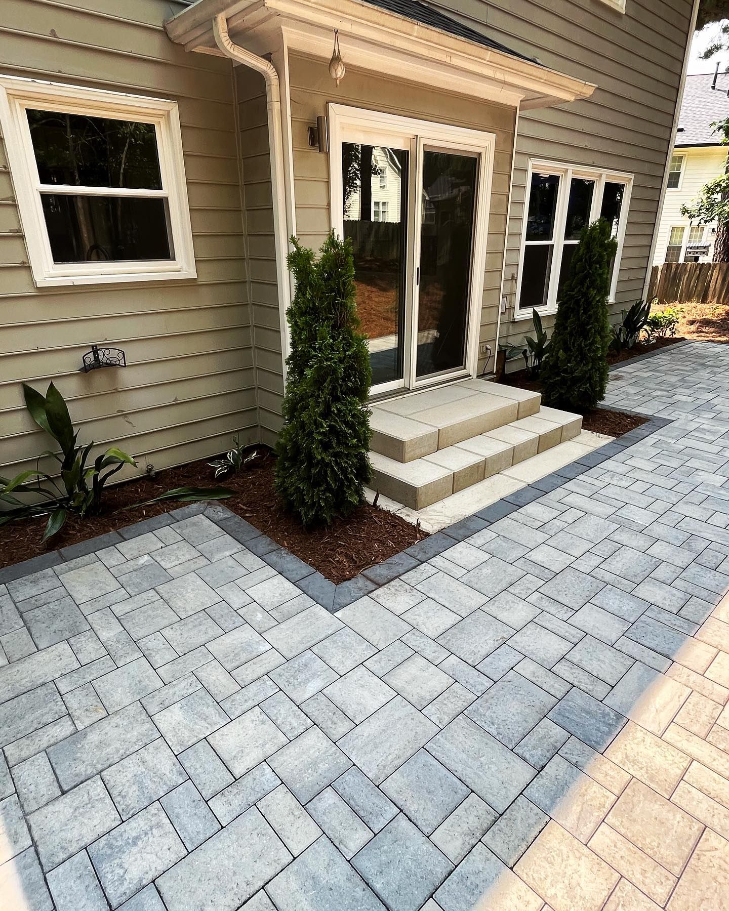 A brick walkway leading to the front door of a house.
