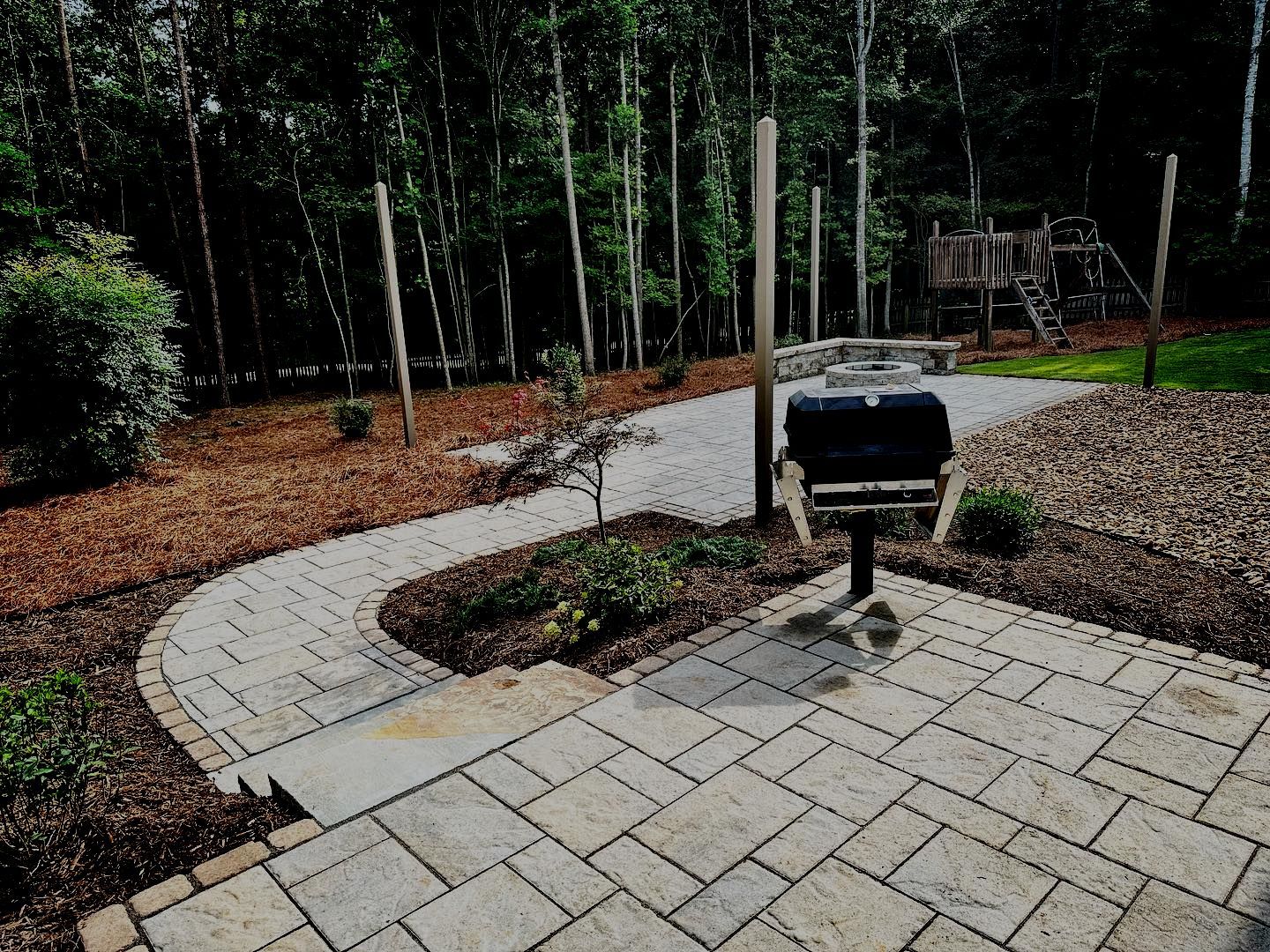 A patio with a grill in the middle of it