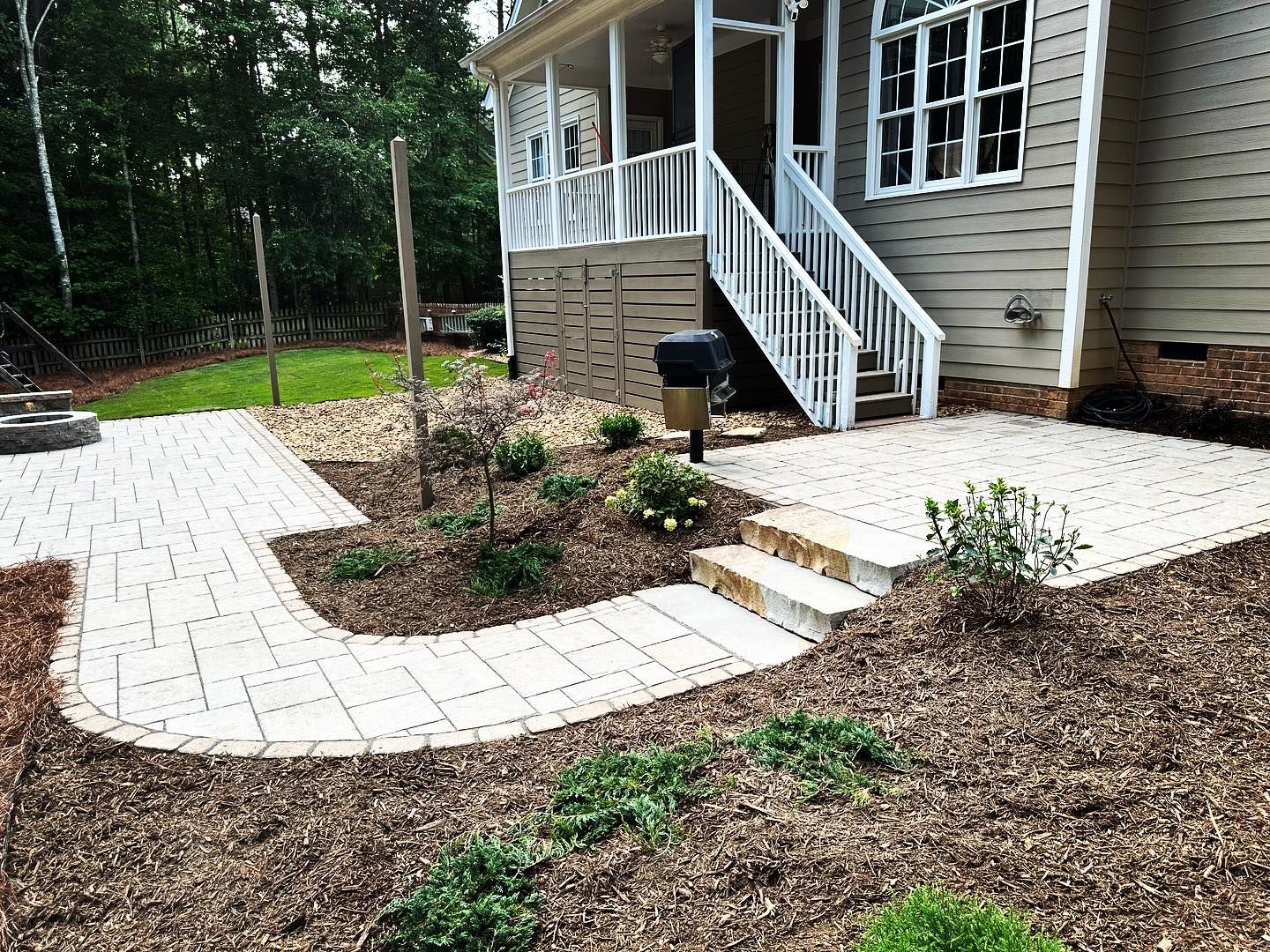 A house with a patio and stairs in front of it