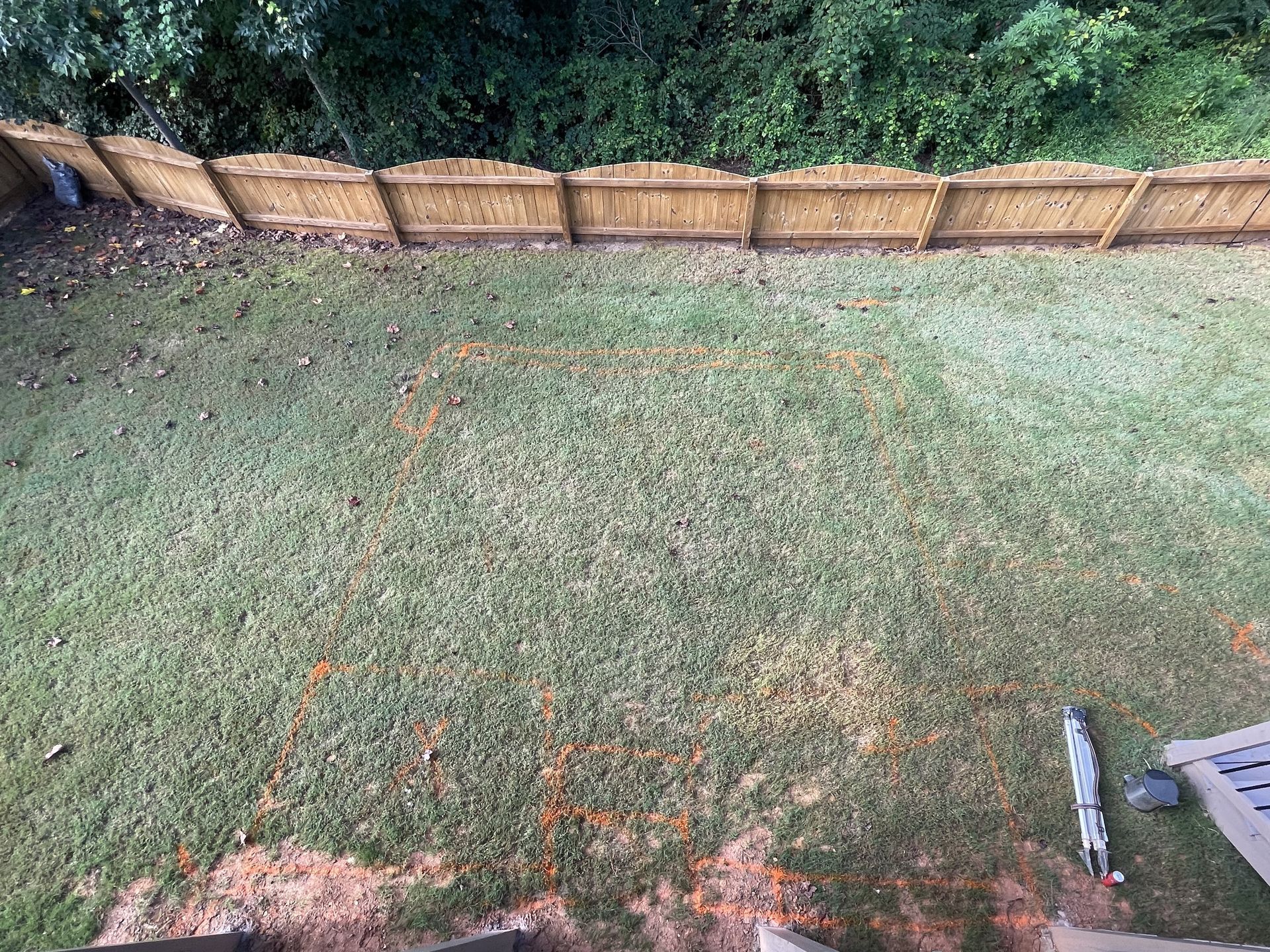 An aerial view of a backyard with a wooden fence.