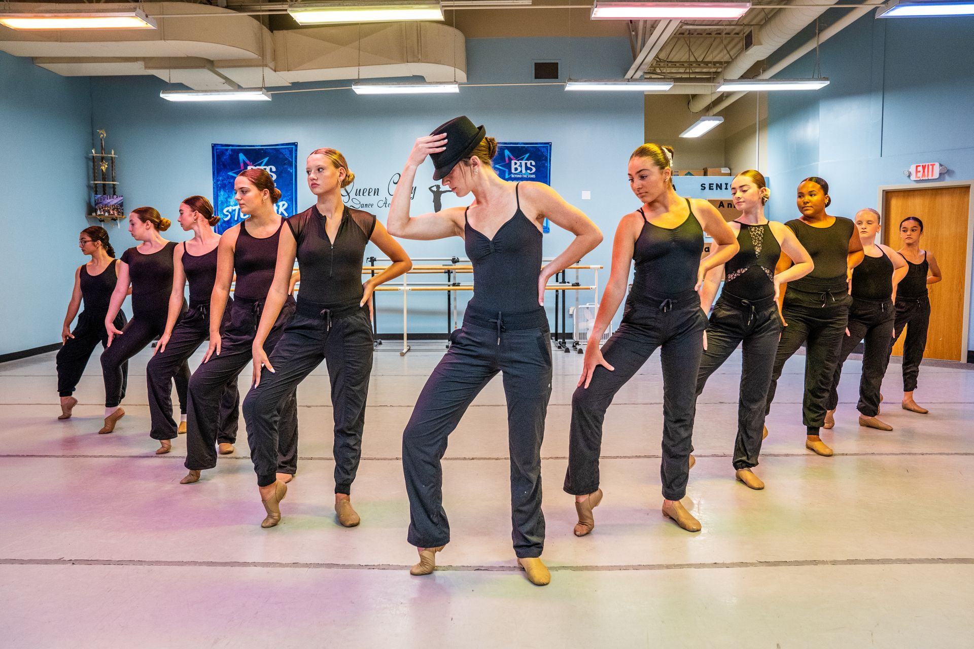 A group of women are dancing in a dance studio.