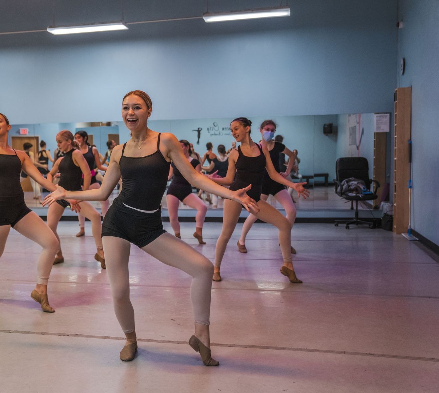 A group of women are dancing in a dance studio