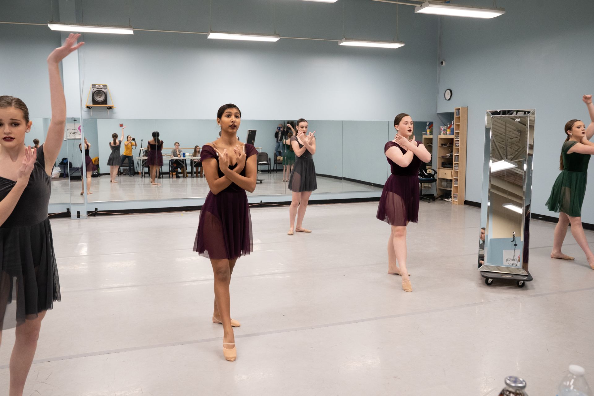 A group of young women are dancing in a dance studio.