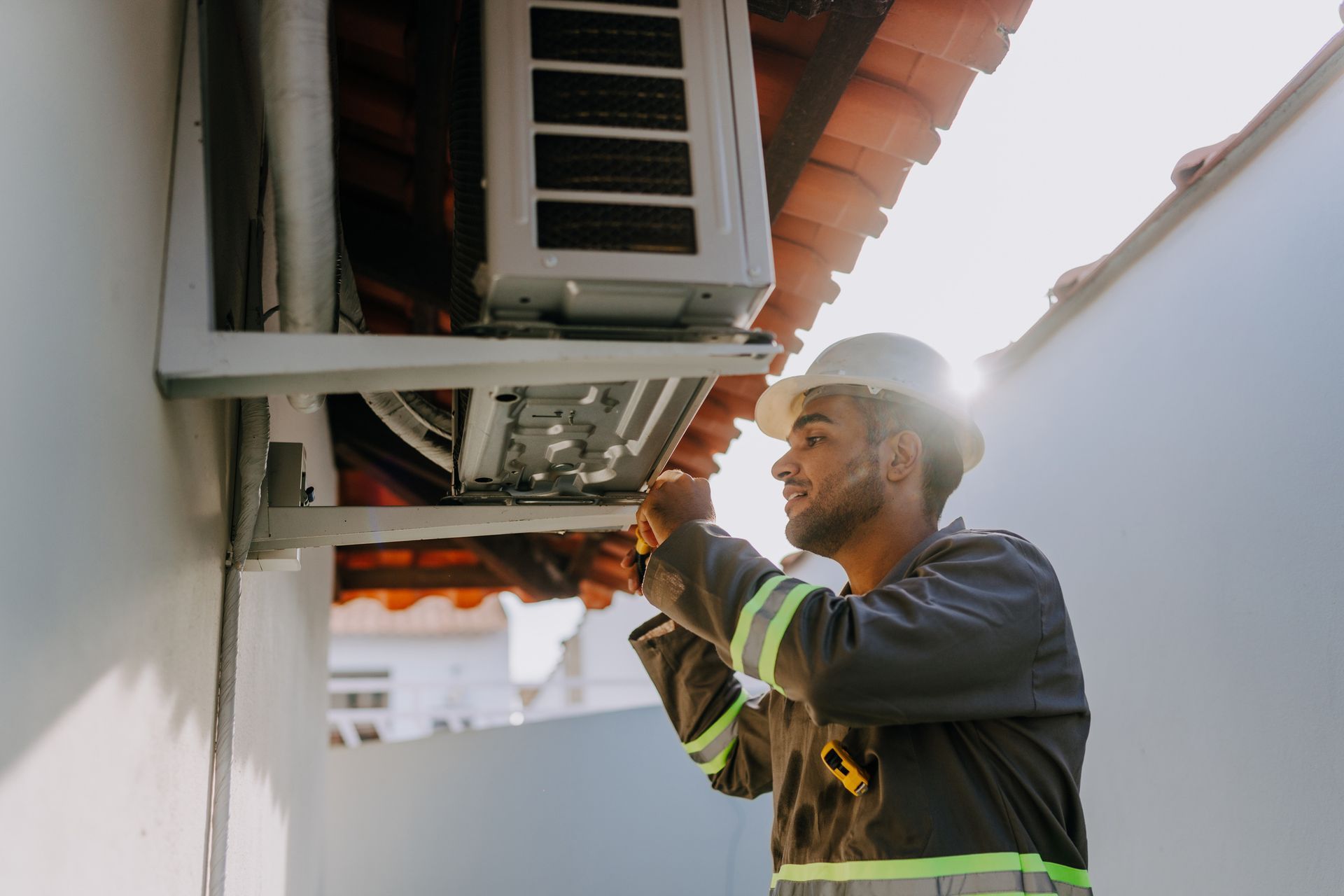 Technician checking air conditioning unit Technician checking air conditioning unit