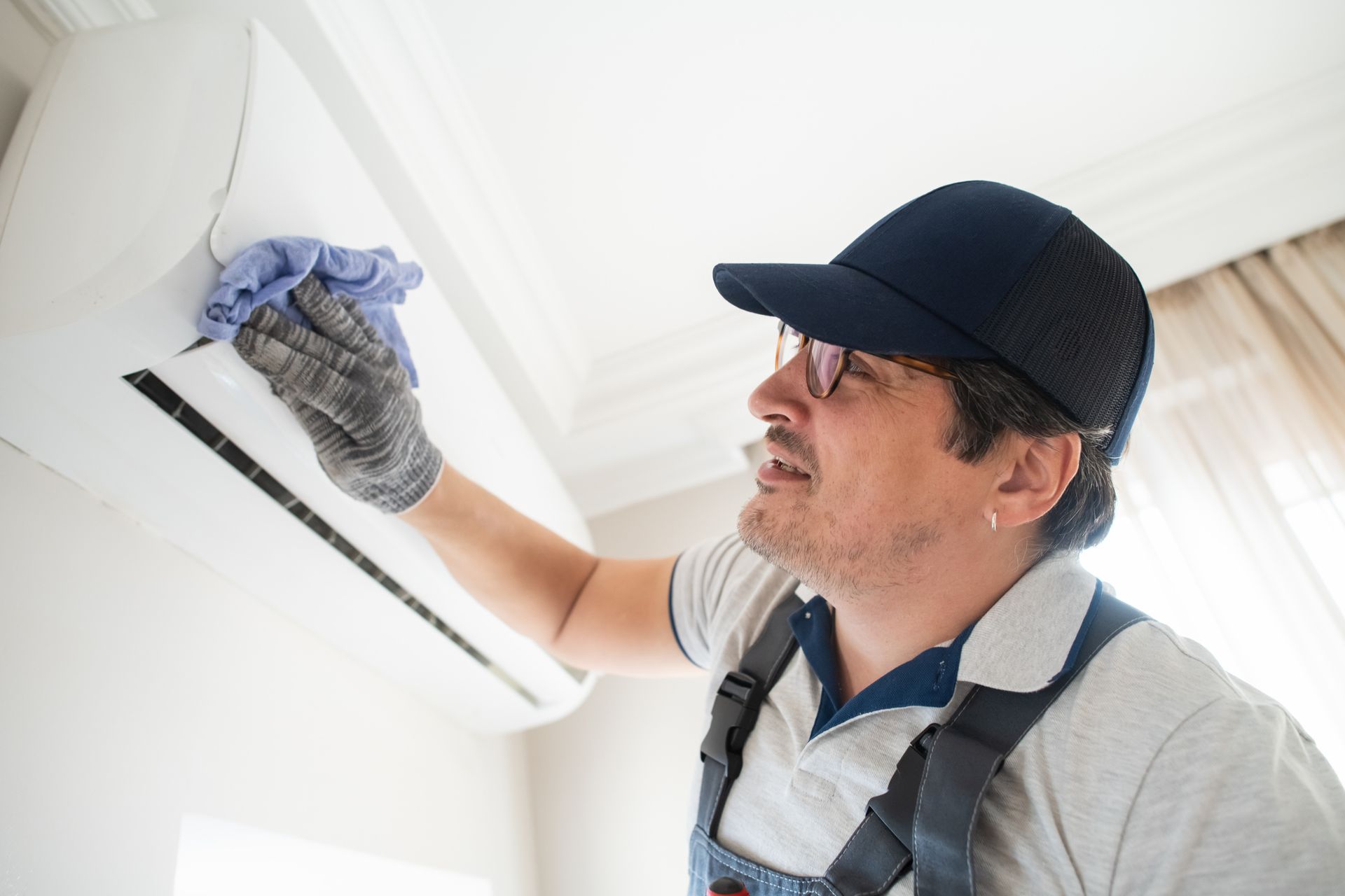 Technician clearing an air conditioner. Technician clearing an air conditioner.