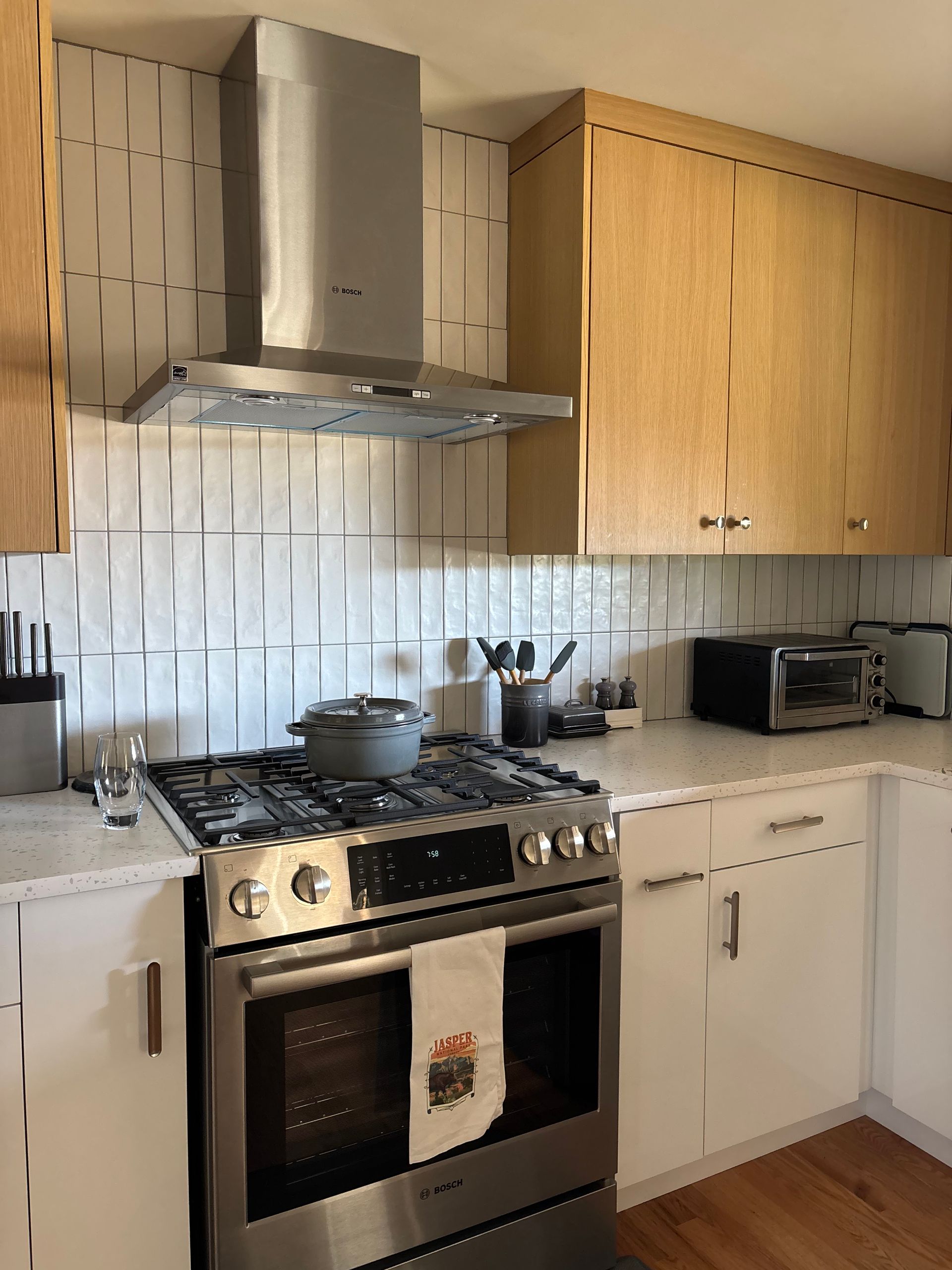A kitchen with stainless steel appliances and wooden cabinets