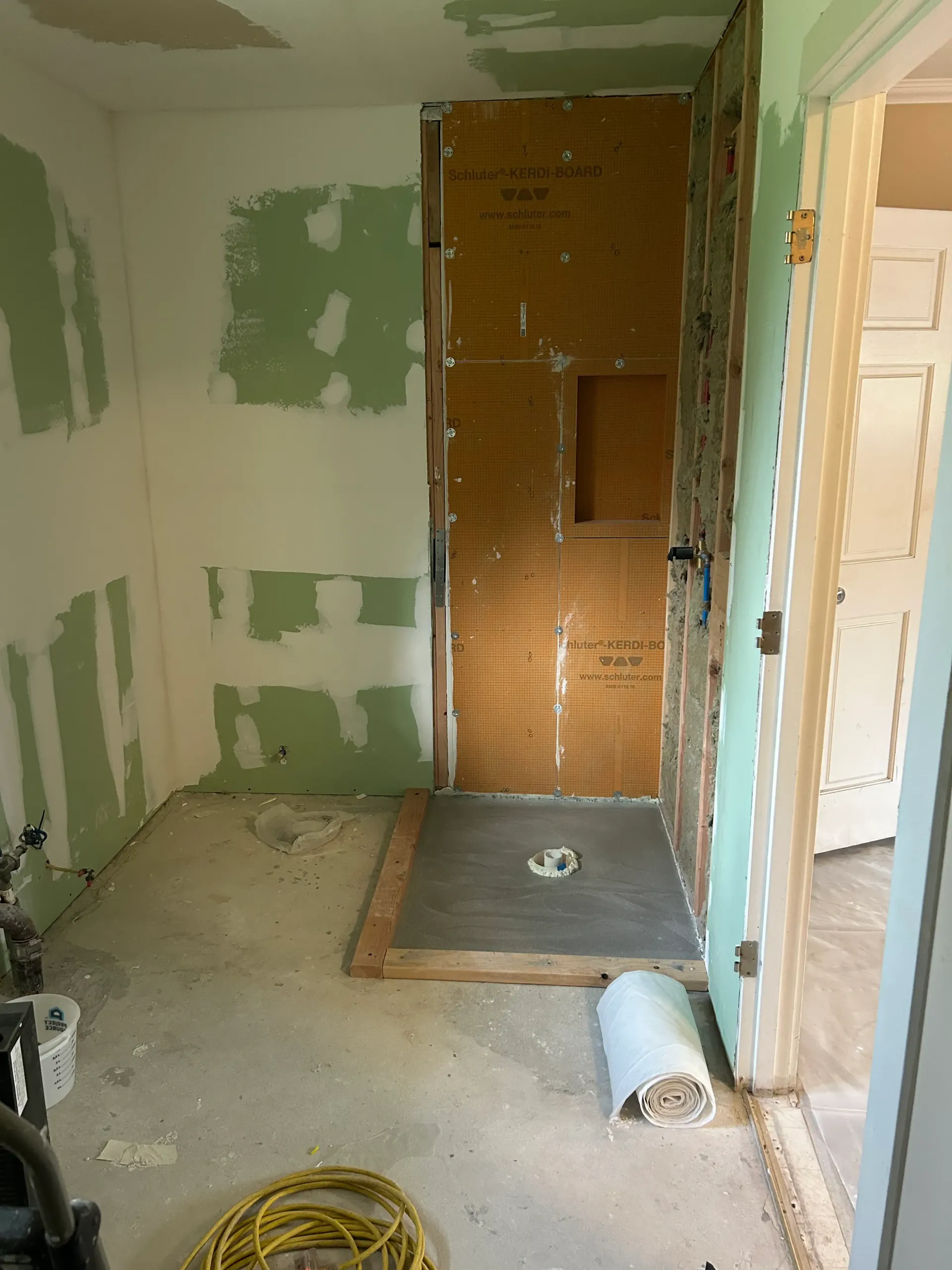 A room that is being remodeled with a vacuum cleaner on the floor.