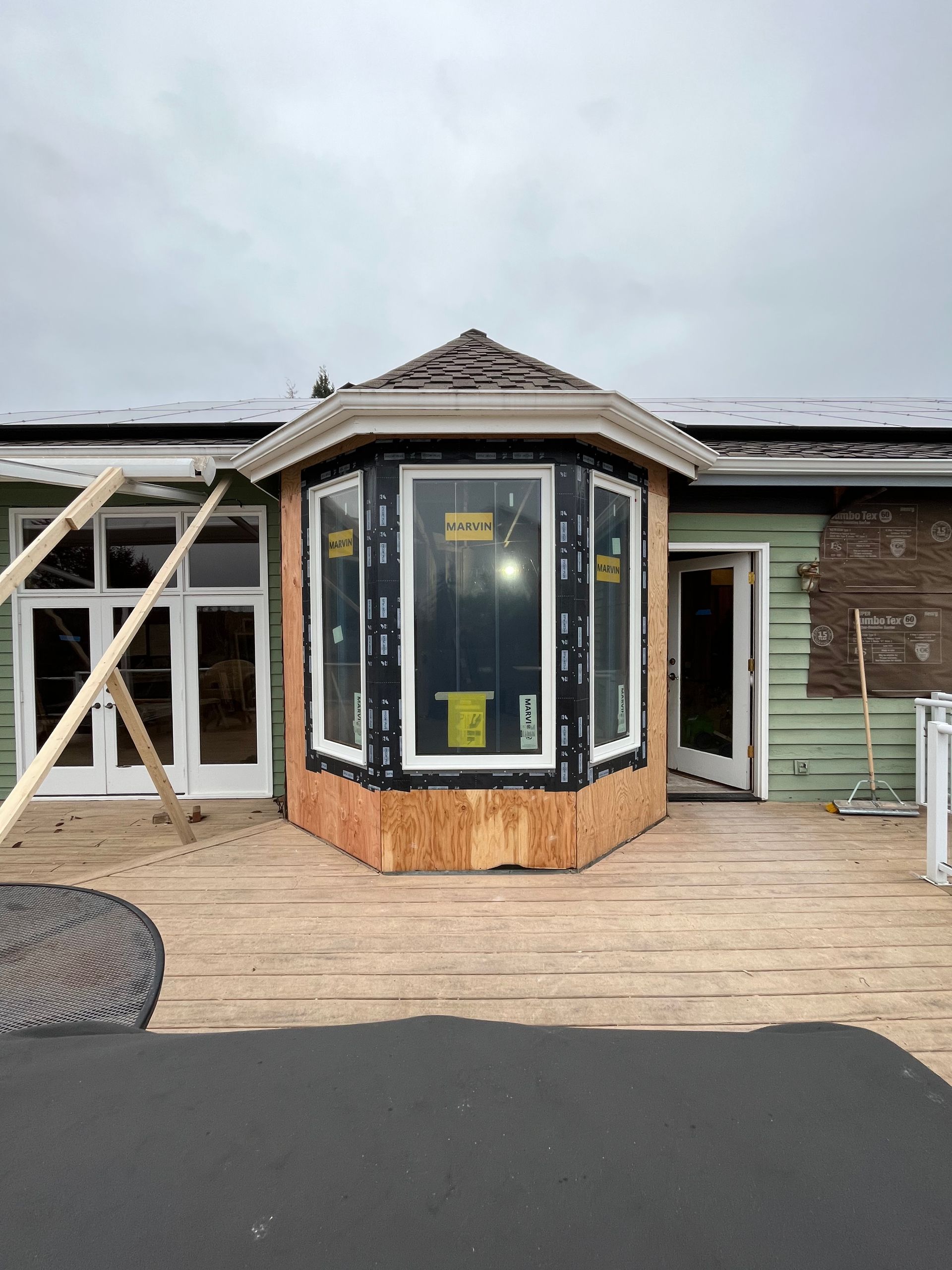 A house is being remodeled with a large bay window.