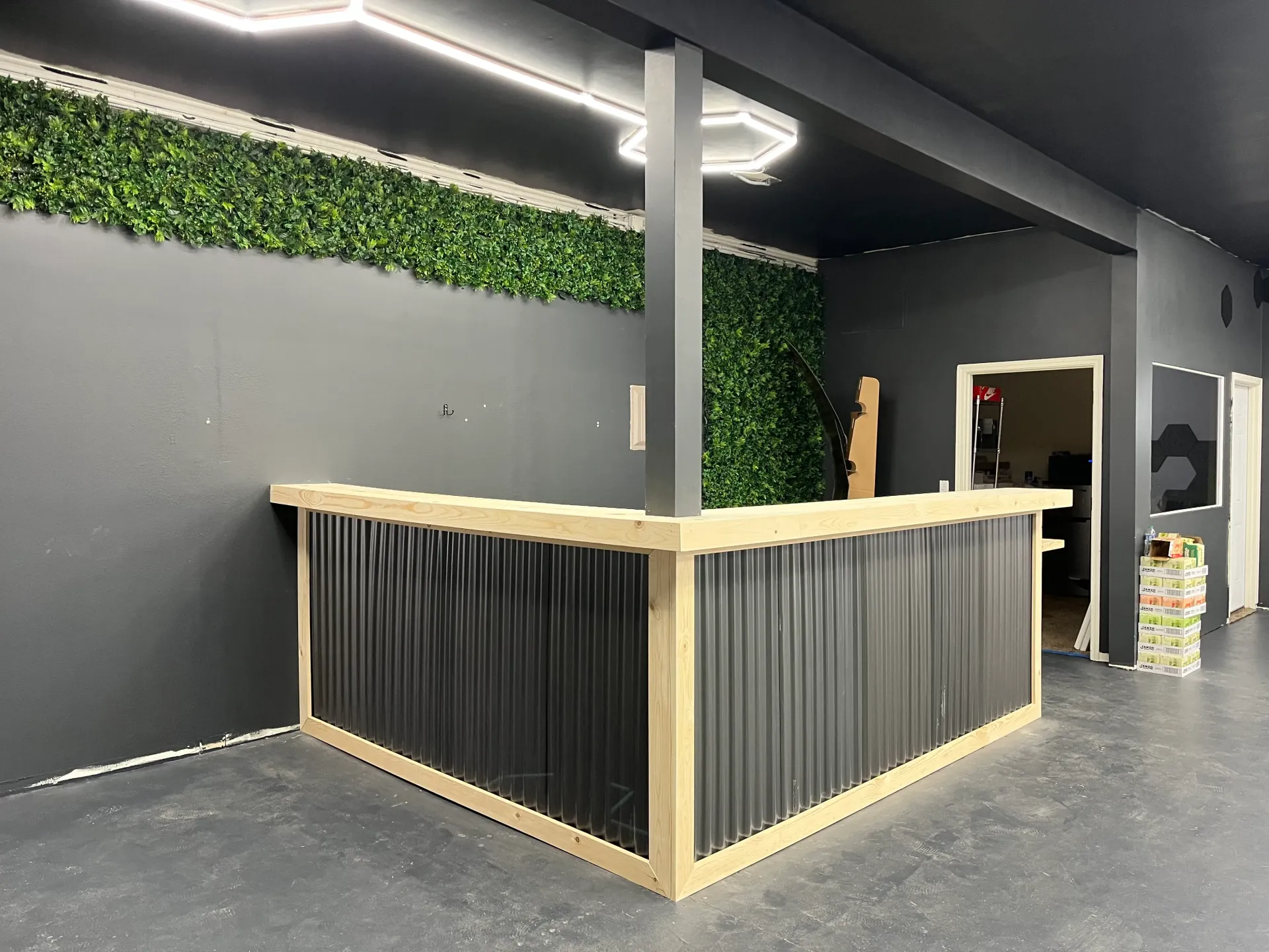 A large black bar in a room with a green wall behind it.