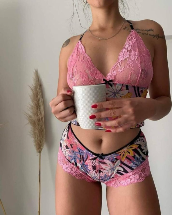 Conjunto de lencería de color rojo con estampado floral y detalles de encaje sobre fondo blanco, que incluye camisola y pantalones cortos.