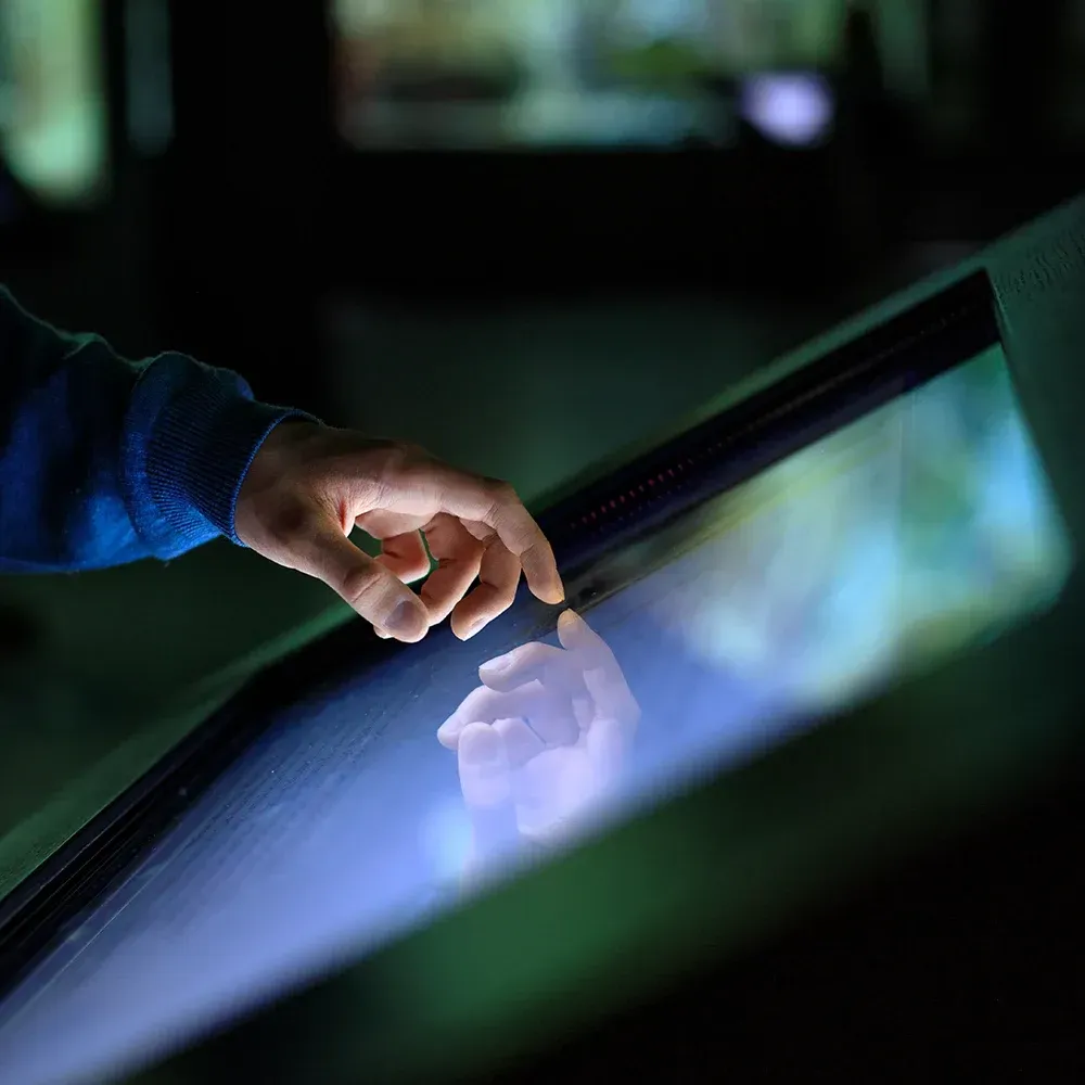 A person touches a screen with their finger