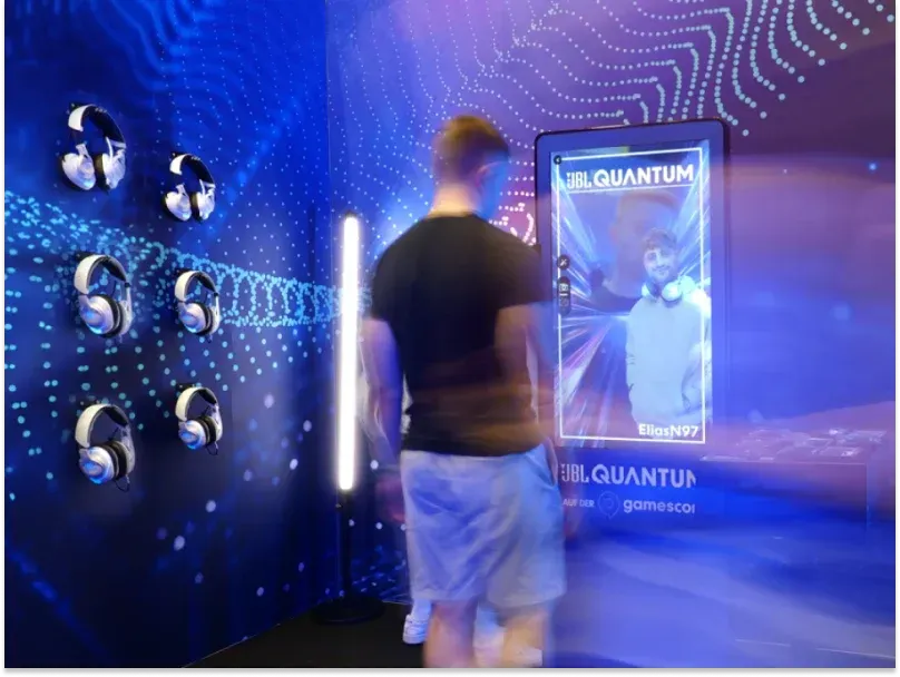 A man stands in front of a screen labeled "Quantum