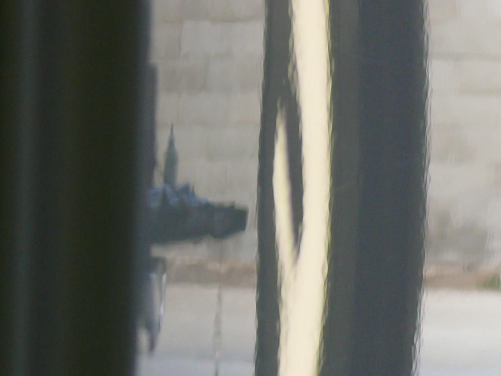 A close up of a window with a reflection of a building in it.