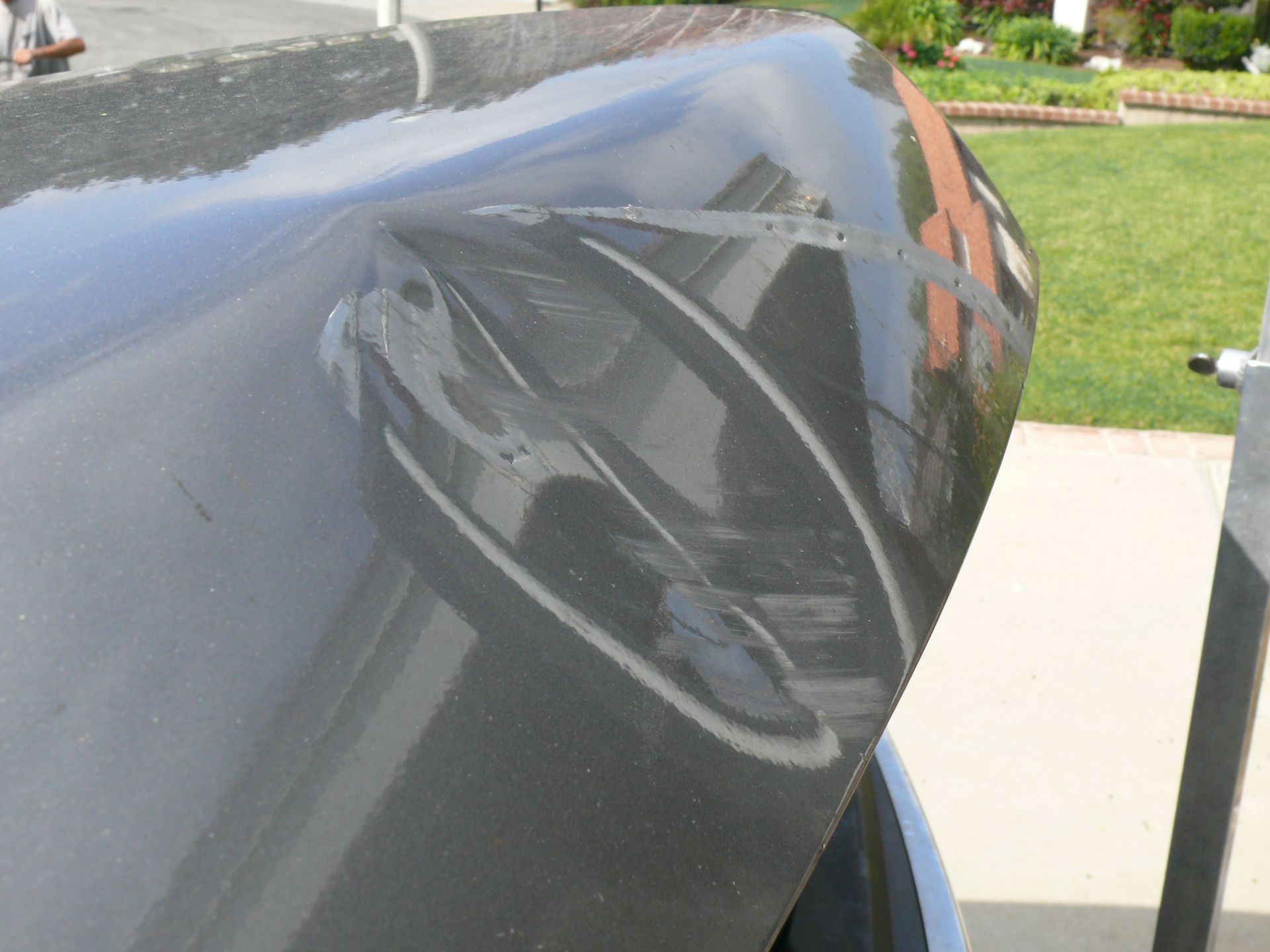 A black car is parked on the side of the road
