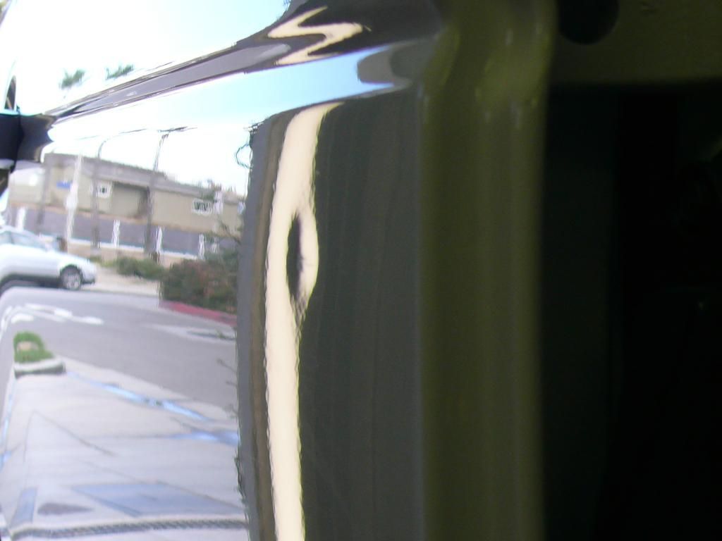 A white car is parked on the side of the road.