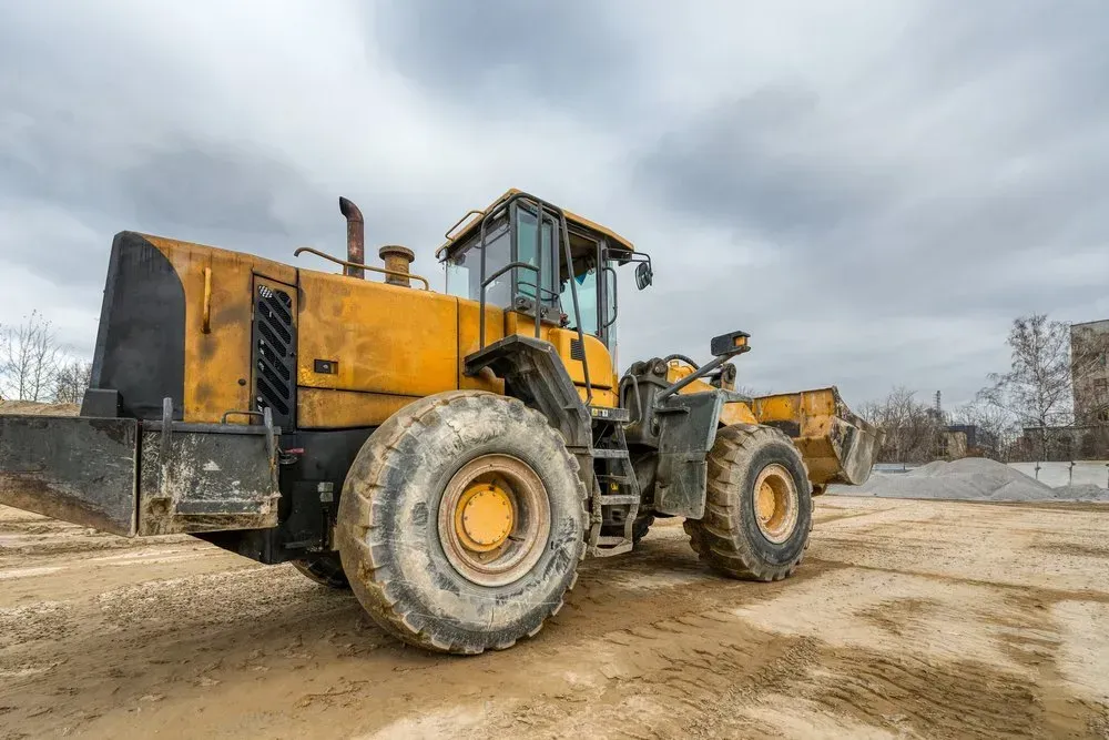 Yellow Construction Wheel Loader on Dirt Under a Cloudy Sky — Jim Anderson Earthmoving Pty Ltd in Coopernook, NSW