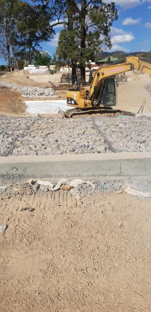 A Yellow Excavator on A Construction Site — Jim Anderson Earthmoving Pty Ltd in Coopernook, NSW