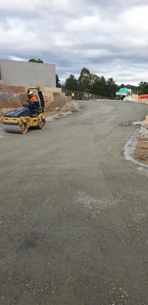 A Road Roller Compacts Gravel on A Construction Site — Jim Anderson Earthmoving Pty Ltd in Coopernook, NSW